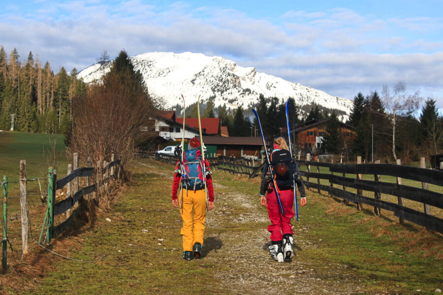 Mangels Schnee werden die Skier für den ersten Teil auf den Rucksack geschnallt. Foto: Michael Pröttel (Mountain Wilderness Deutschland)